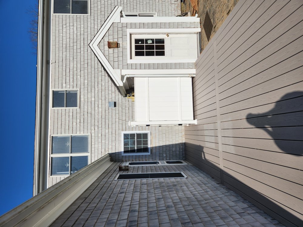Work on custom white vinyl outdoor shower using Barette Outdoor fencing panels